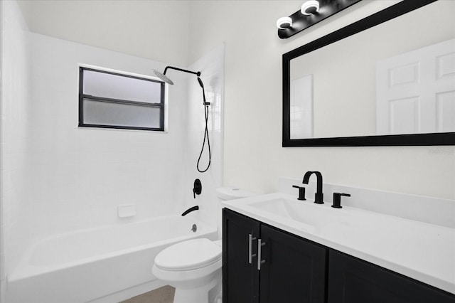 full bathroom with tiled shower / bath, vanity, and toilet