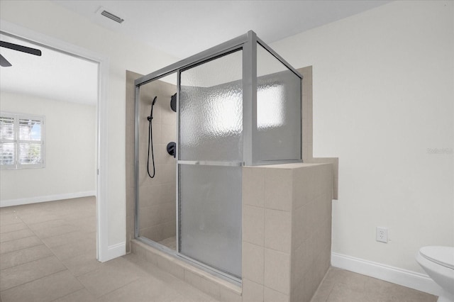 bathroom featuring walk in shower, ceiling fan, tile patterned floors, and toilet