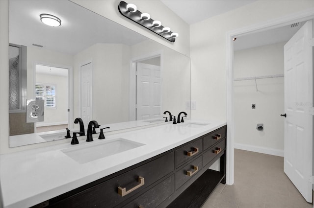 bathroom with double vanity, a sink, and visible vents