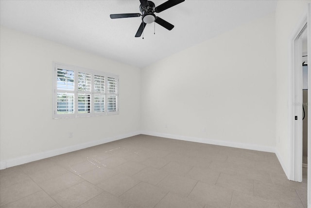 empty room with baseboards and a ceiling fan