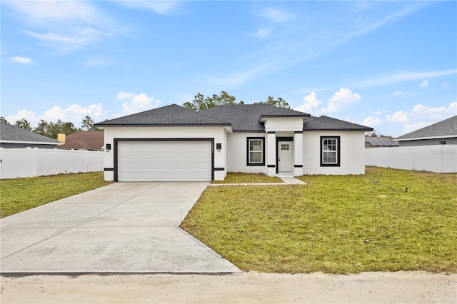 view of front of home with a garage and a front yard