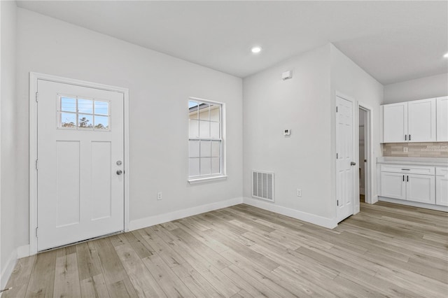 foyer entrance with light hardwood / wood-style floors