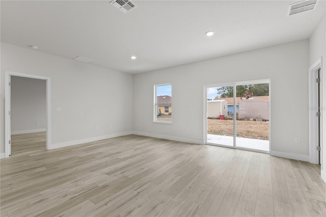 spare room with light hardwood / wood-style flooring