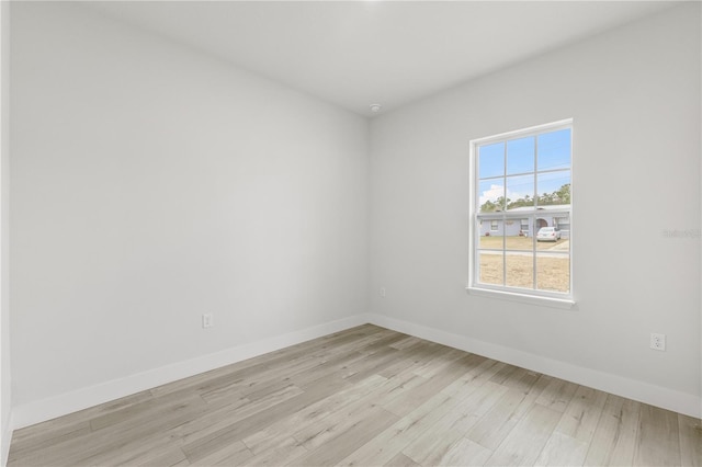 empty room with light hardwood / wood-style flooring