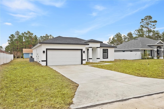 view of front of home featuring a garage, central air condition unit, and a front lawn