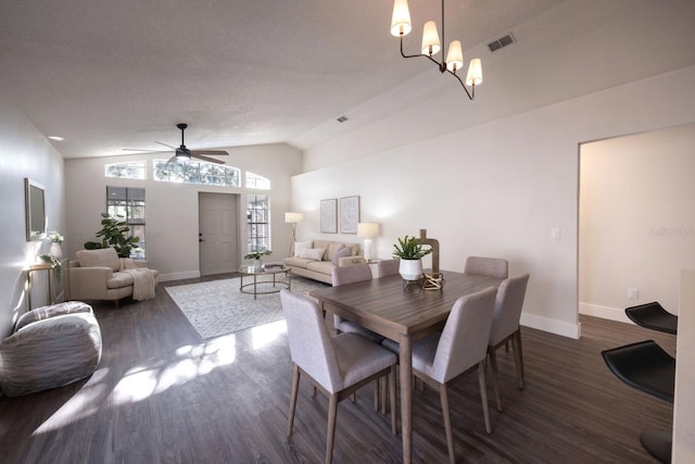 dining room featuring lofted ceiling, dark hardwood / wood-style floors, and ceiling fan with notable chandelier