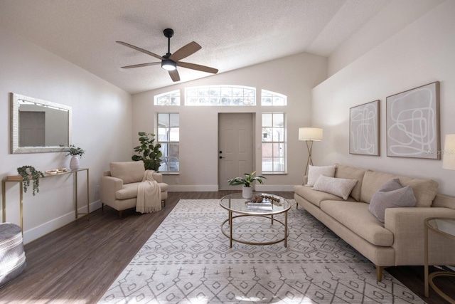 living room featuring vaulted ceiling, ceiling fan, a textured ceiling, and dark hardwood / wood-style flooring