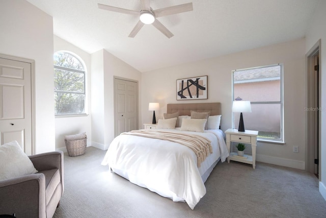 bedroom with vaulted ceiling, ceiling fan, and carpet