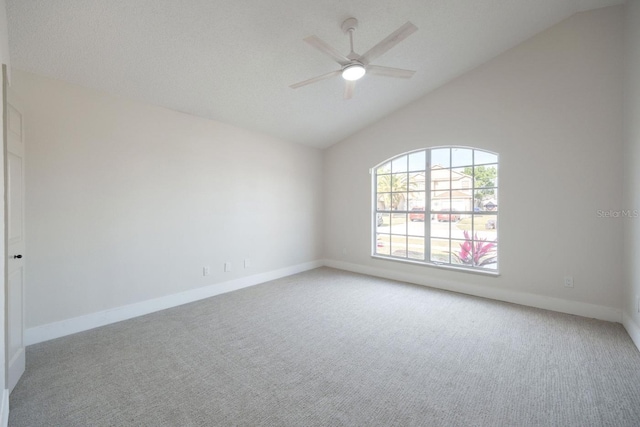 spare room with lofted ceiling, light carpet, a textured ceiling, and ceiling fan