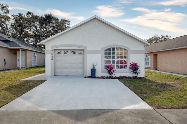 single story home featuring a garage and a front lawn