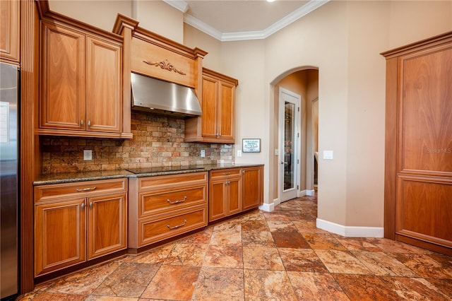 kitchen with backsplash, dark stone counters, ornamental molding, exhaust hood, and black electric cooktop