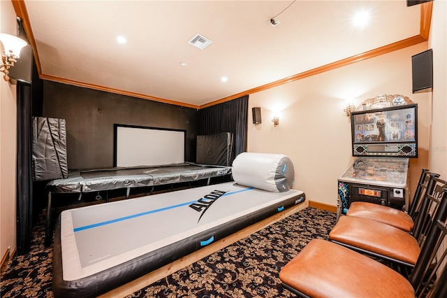 cinema room featuring ornamental molding and carpet flooring