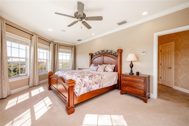 carpeted bedroom featuring crown molding and ceiling fan