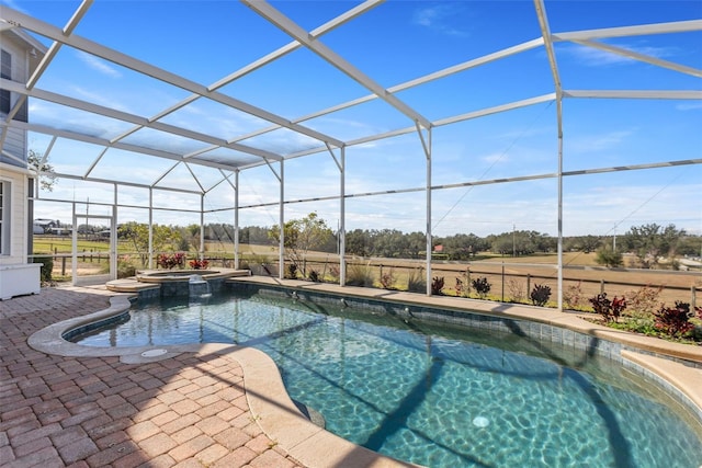 view of pool featuring an in ground hot tub, glass enclosure, and a patio