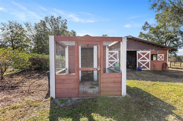 view of outdoor structure with a lawn