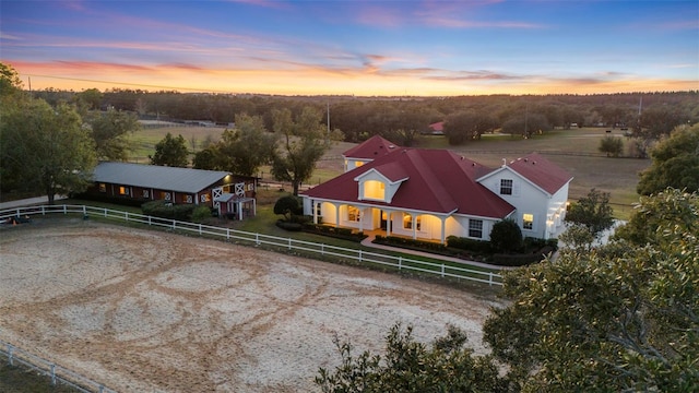 aerial view at dusk featuring a rural view