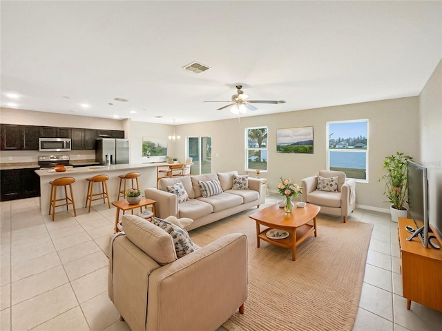 tiled living room with ceiling fan