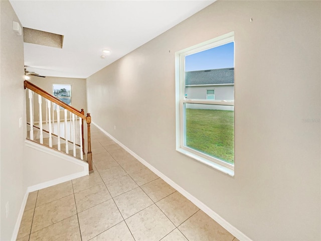 hall featuring light tile patterned floors