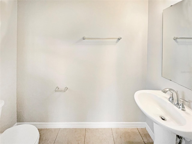 bathroom featuring tile patterned flooring, sink, and toilet