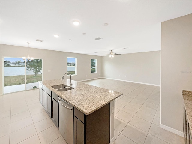 kitchen featuring sink, hanging light fixtures, a water view, light stone countertops, and stainless steel dishwasher