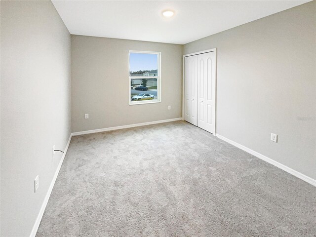 unfurnished bedroom featuring a closet and carpet flooring