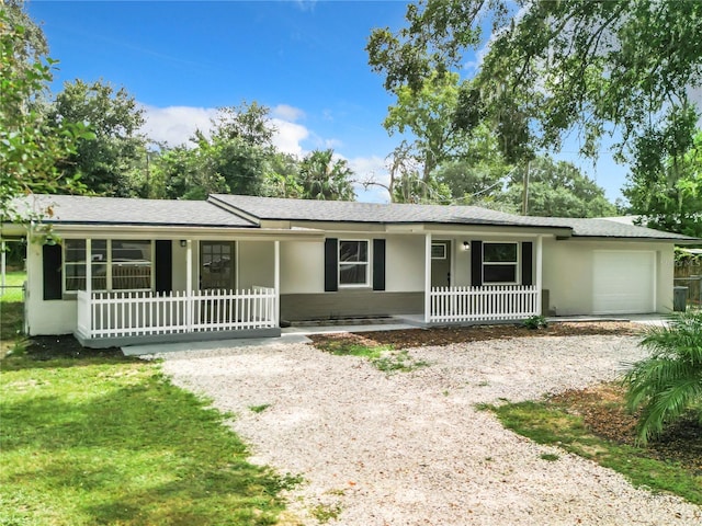 ranch-style house featuring a garage and a porch