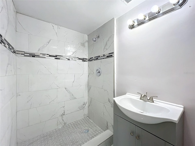 bathroom with vanity and tiled shower