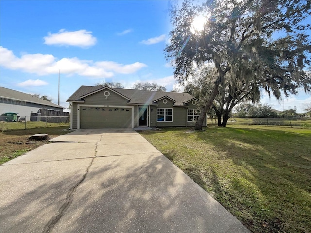 ranch-style house featuring a garage and a front lawn