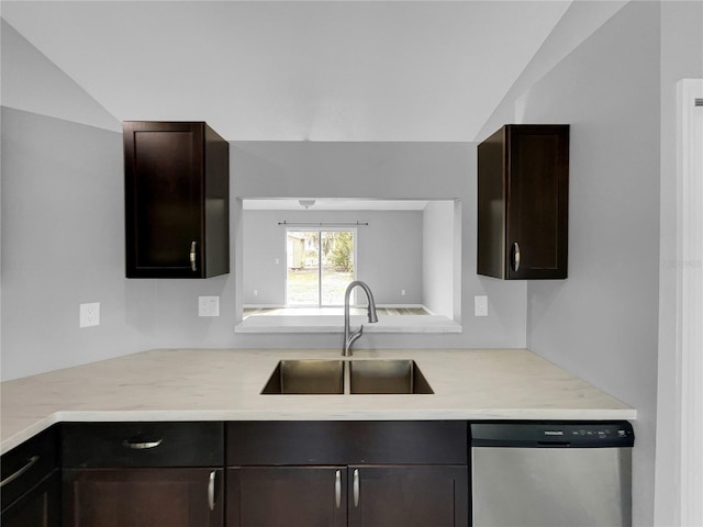 kitchen featuring lofted ceiling, sink, dark brown cabinetry, and dishwasher