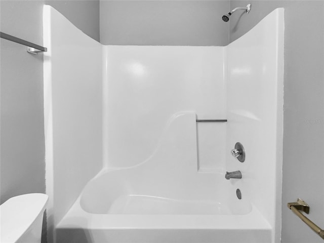 bathroom with shower / bathtub combination and toilet