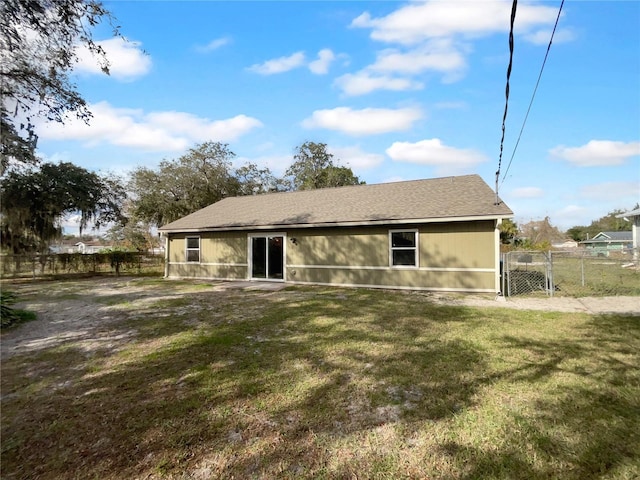 back of property featuring a lawn