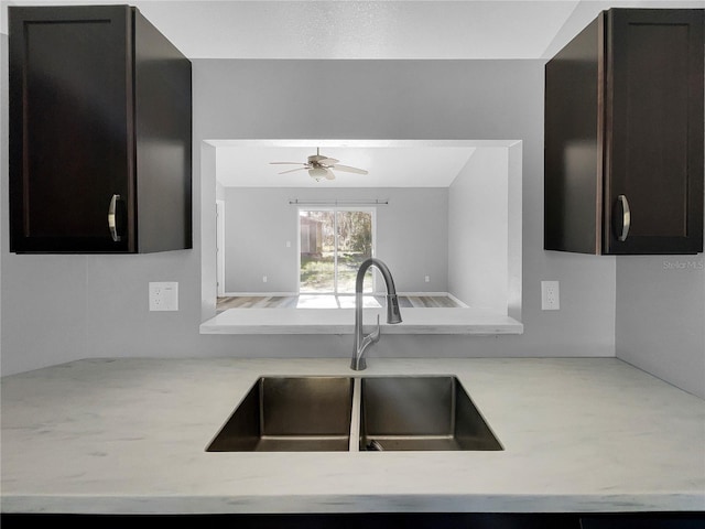 kitchen featuring sink, light stone countertops, and ceiling fan