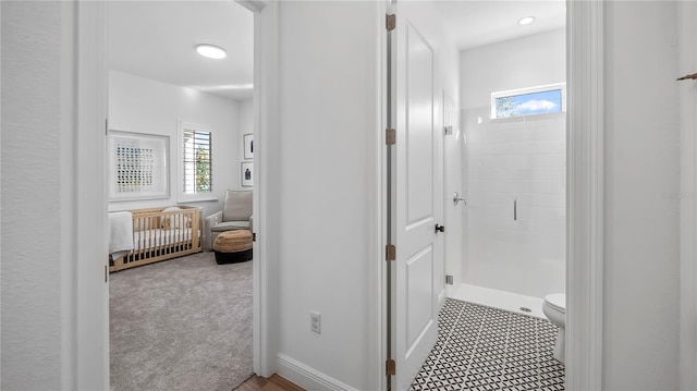 bathroom featuring an enclosed shower and toilet