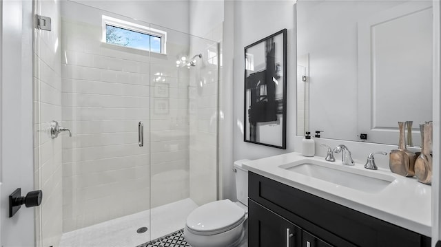 bathroom featuring a shower with door, vanity, and toilet