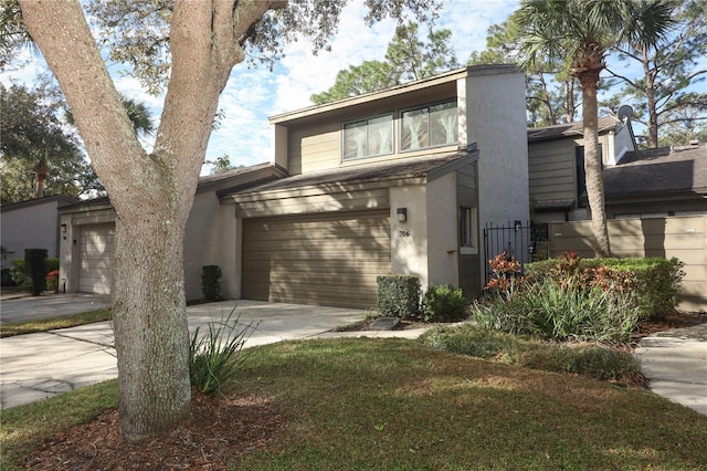 view of front facade with a garage and a front lawn