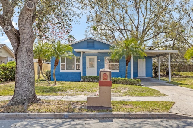 bungalow with a front yard and a carport