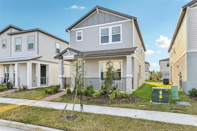 craftsman inspired home featuring a porch and a front lawn