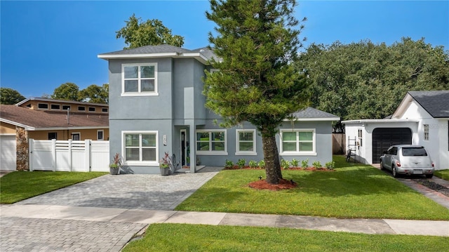 view of front of home featuring a garage and a front lawn