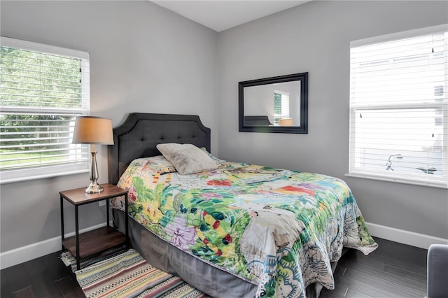 bedroom with dark hardwood / wood-style floors