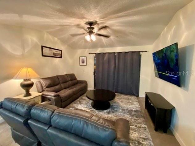 living room with lofted ceiling and ceiling fan