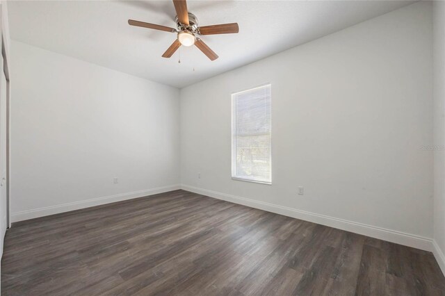 unfurnished room with ceiling fan and dark hardwood / wood-style flooring