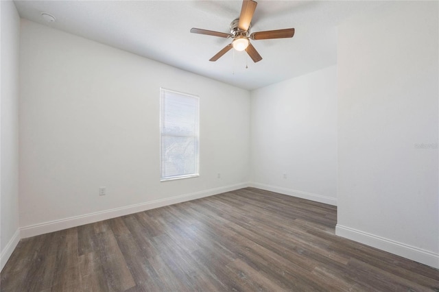 empty room with dark wood-type flooring and ceiling fan