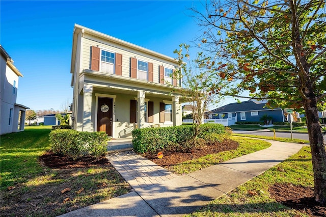 view of front of property with a porch and a front lawn