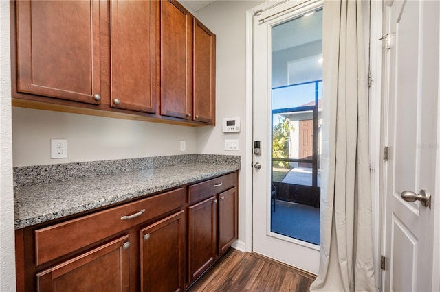 kitchen featuring dark hardwood / wood-style floors and light stone counters