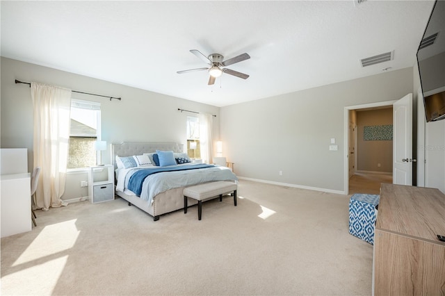 bedroom featuring light carpet and ceiling fan