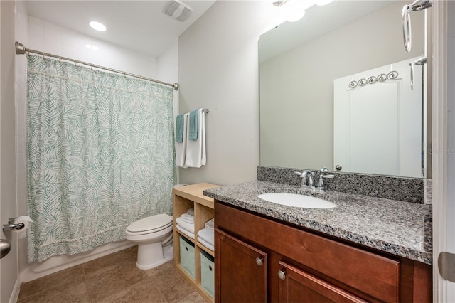 bathroom with tile patterned flooring, vanity, and toilet