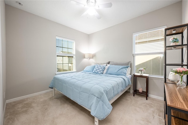 bedroom with ceiling fan and light colored carpet