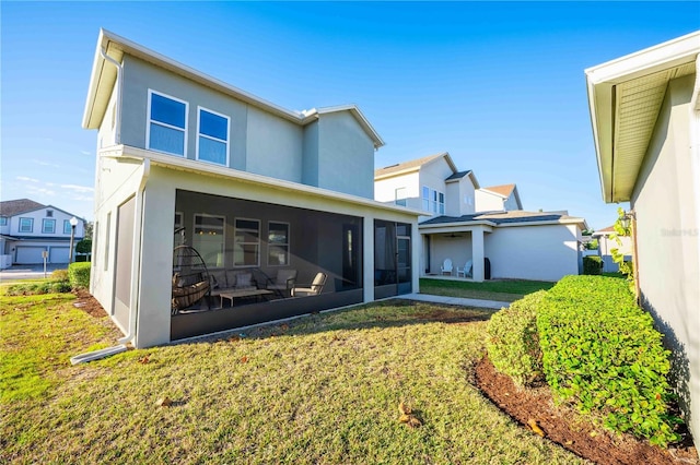 rear view of property featuring a yard and a sunroom