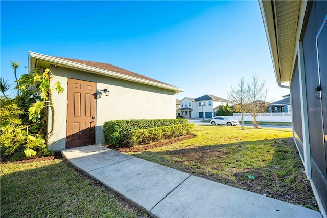 property entrance featuring a lawn