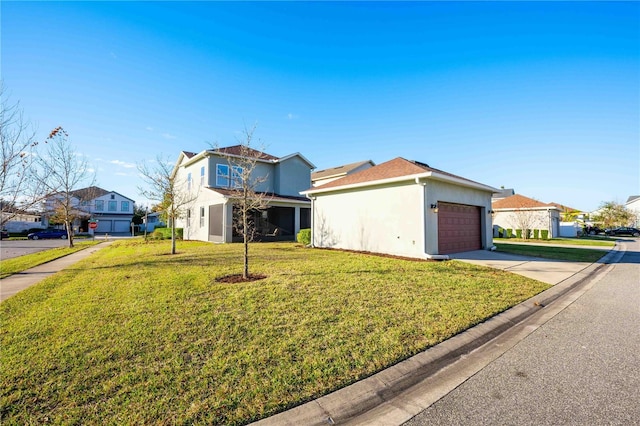 front facade featuring a garage and a front yard